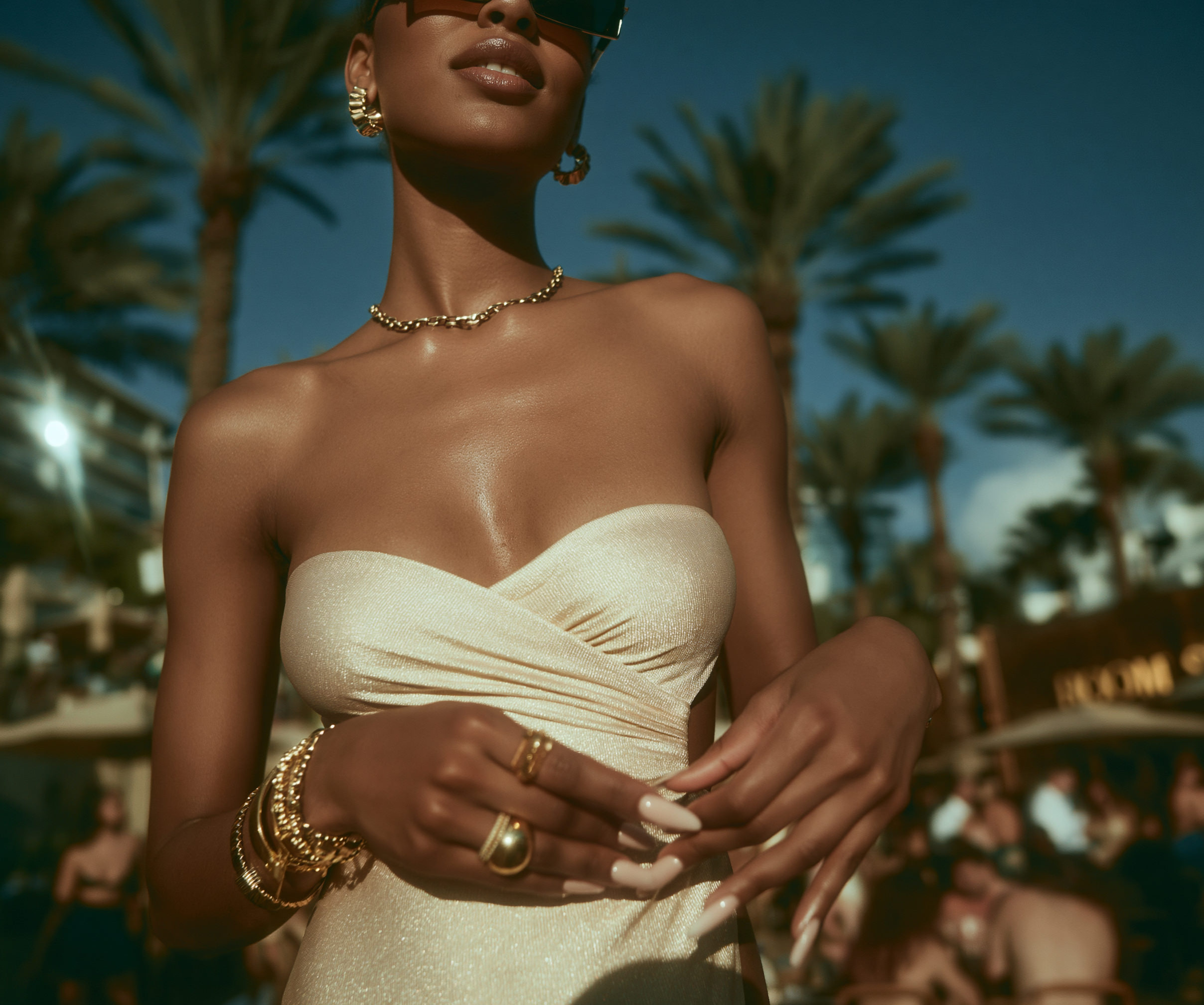 Garden portrait — strapless cream dress against palms